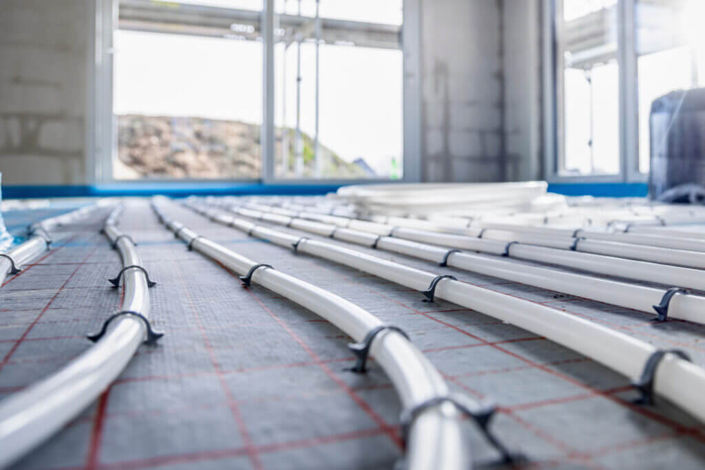 Professionelle Fußbodenheizung-Installation mit verlegten Heizungsrohren auf Dämmung für energieeffizientes Heizen
